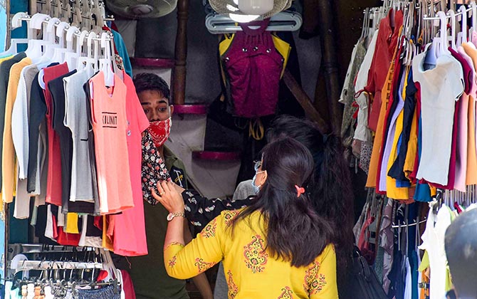 Guwahati: People buy clothes from a garment shop that was opened after state authorities eased restrictions, during ongoing COVID-19 lockdown in Guwahati, Monday, May 4, 2020. (PTI Photo) (PTI04-05-2020_000160B)