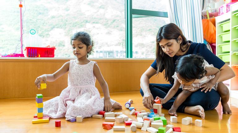 Indian family play toy block together at home